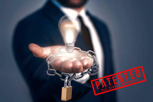 istock A man holding light bulb, lock and chain. Patented Idea Concept. All rights reserved 1154830979