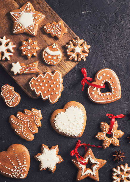 istock Gingerbread christmas and happy new year cookies background on black texture 1154831421