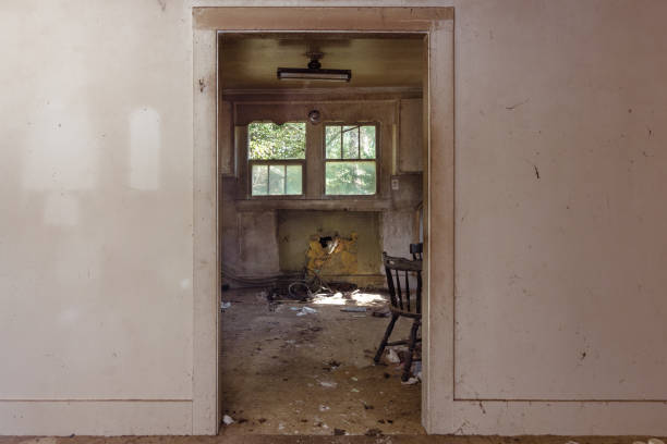 istock Looking through doorway into trashed kitchen in an abandoned home 1154831602