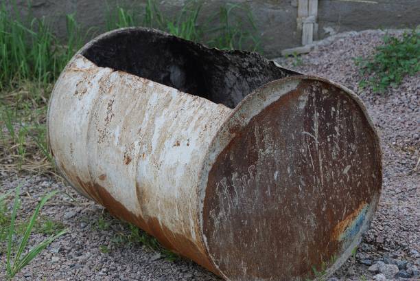 istock one big rusty old and dirty barrel lies on the ground 1154834171