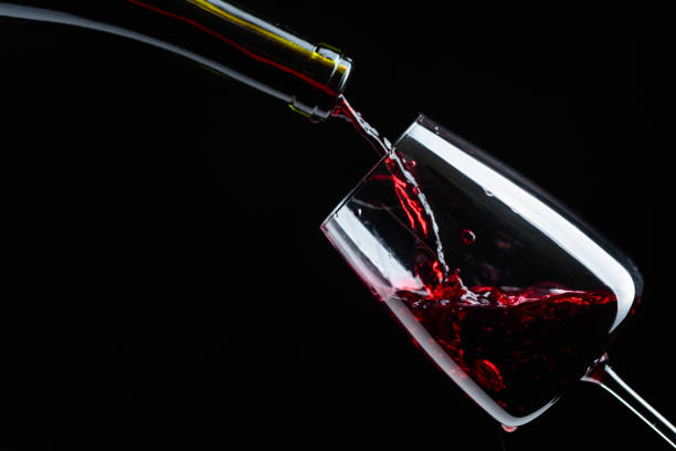 istock Red wine being poured into wineglass. 1154835212