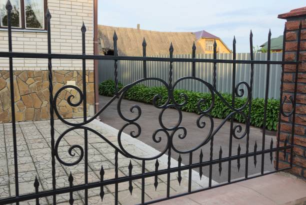 istock black metal fence from rods in a knitted pattern 1154835224