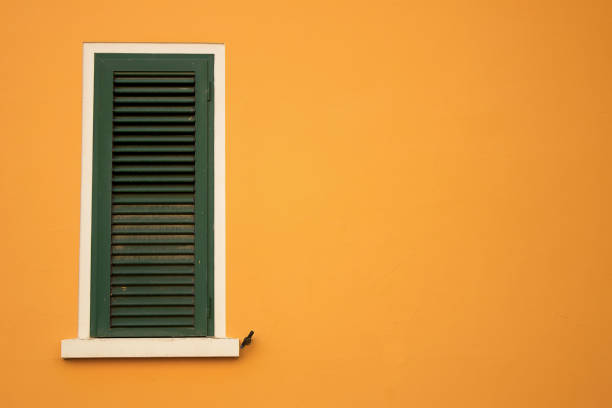istock Green window on a yellow wall 1154836503