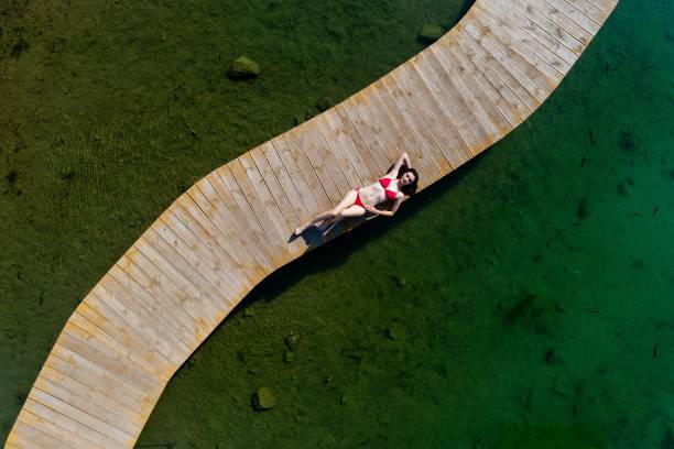 istock Woman in swimsuit relaxing on vacations. 1154836590