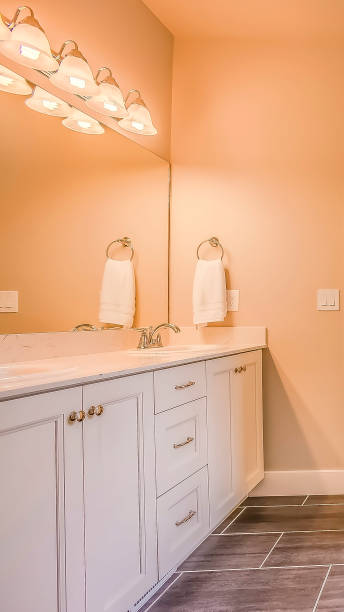 istock Vertical Bathroom interior with built in bathtub shower stall and vanity area 1154837848