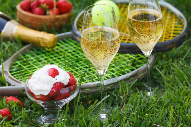 Enjoing in Wimbledon tennis championship with champagne and strawberries with cream. stock photo