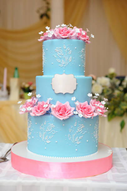 istock A beautiful three-tiered wedding cake decorated with blue mastic, molded with rose flowers from mastic. Close-up 1154839368