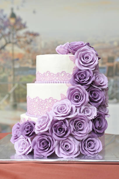 istock A beautiful three-tiered wedding cake decorated with mastic and roses molded mastic flowers of lilac color. Close-up 1154839383