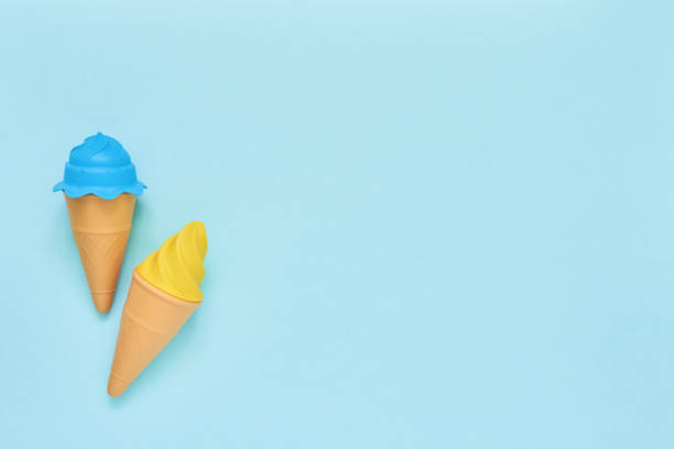 istock Blue and yellow toy ice-cream on light blue background. Summer concept. Top view, copy space. 1154840749