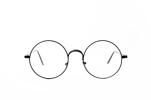 Round black-rimmed glasses are located frontally on a white background. Isolated.