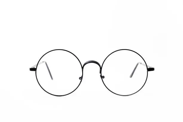 Photo of Round black-rimmed glasses are located frontally on a white background.