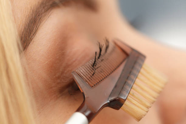 istock Woman brushing her eyelashes 1154842093