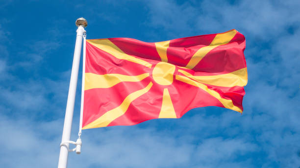 North macedonia flag waving in sunny blue sky. North macedonia flag waving in sunny blue sky. north macedonia stock pictures, royalty-free photos & images