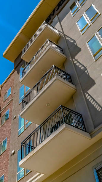istock Panorama frame View from below of a building with small balconies on a sunny day 1154845065