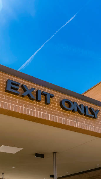 istock Panorama frame Exit Only sign on the exterior of a building against blue sky on a sunny day 1154845068
