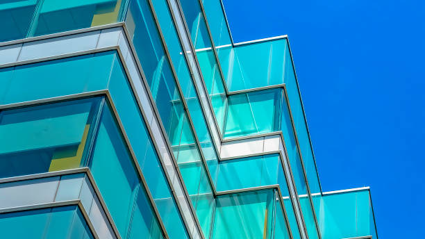 istock Panorama frame Modern building exterior viewed from below with blue sky in the background 1154845103