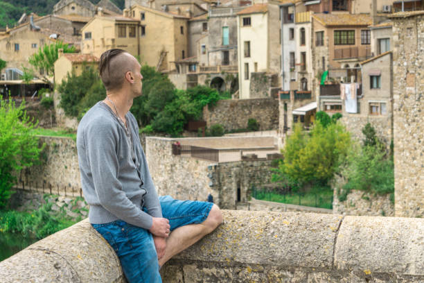 istock Man looking at old medieval Spain town Besalu from bridge 1154845401