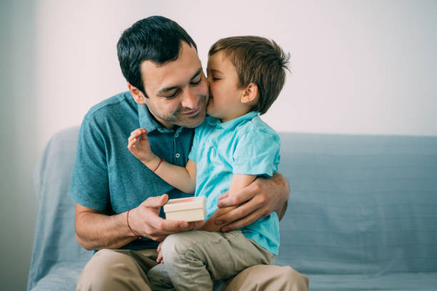 istock Boy surprising his father with a gift for Father's Day 1154847102