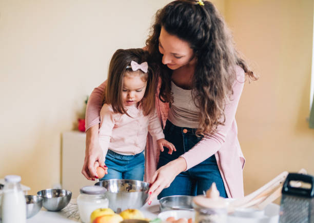 istock Happy mother and daughter in kitchen 1154847105