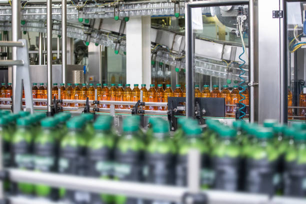 istock Conveyor belt or line in beverage plant with modern industrial machine equipment. Plastic bottles with fresh organic juice in factory interior 1154847853
