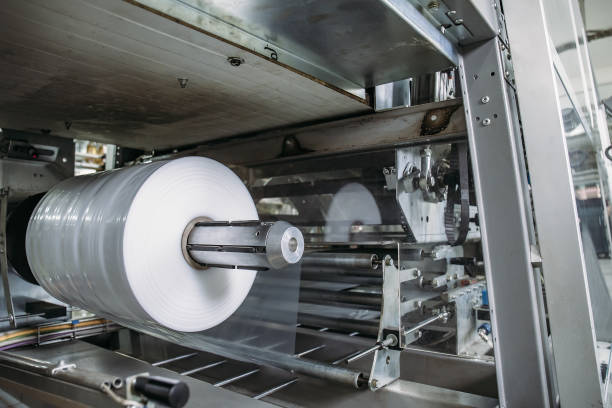 istock Plastic roll in industrial food packaging machine equipment tool at factory workshop 1154847955