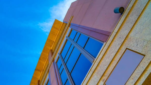 istock Panorama frame Commercial building exterior with cylindrical wall lights and blue windows 1154850360