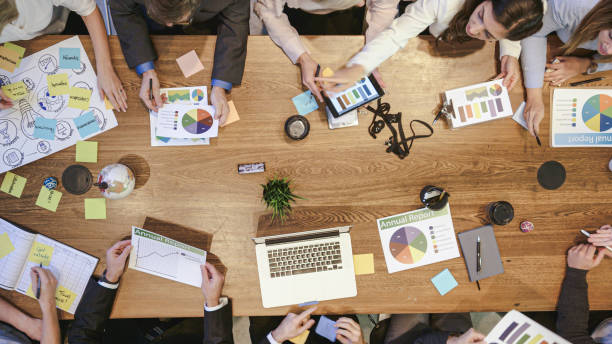 istock High Angle View of Business Development Team in Strategy Meeting 1154851615