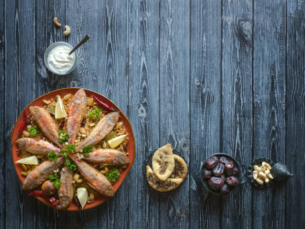istock Arabian Fish Kabsa on a dark wooden background. 1154851748