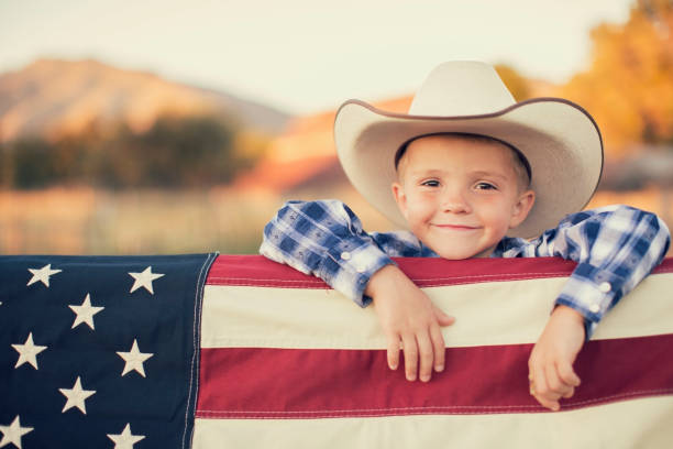 istock Young Cowboy with American Flag 1154852938