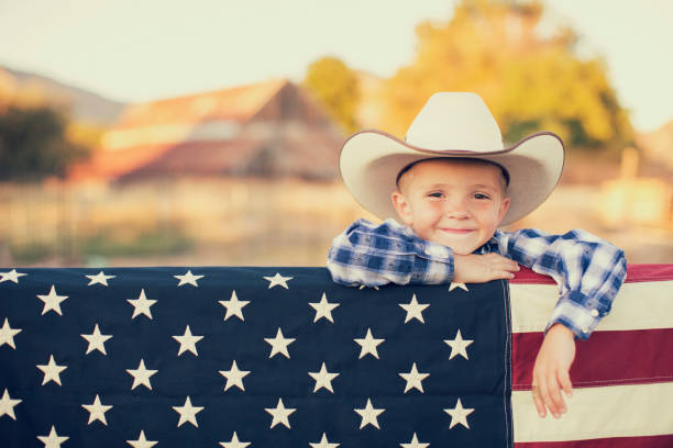 istock Young Cowboy with American Flag 1154852939