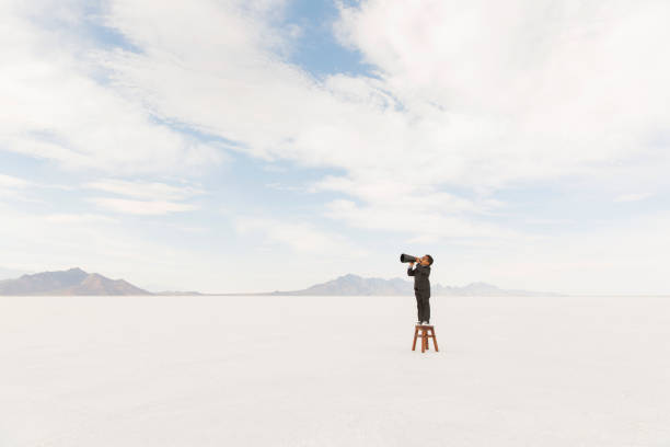 istock Young Businessman on a Stool with a Megaphone 1154854247