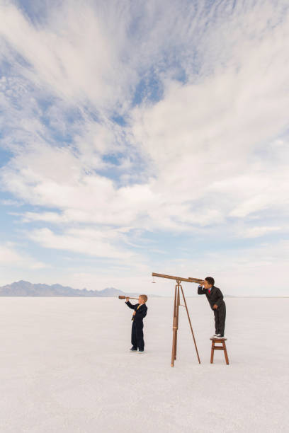 istock Young Businessmen with Telescopes 1154854249