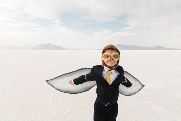 istock Young Business Boy with Cardboard Wings 1154854323