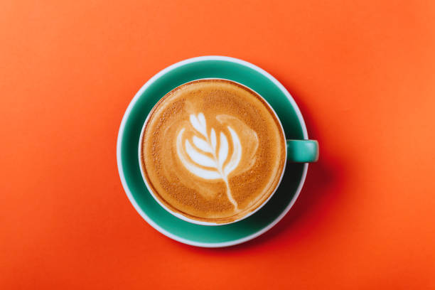 istock Cyan coffee cup over orange background. 1154854340