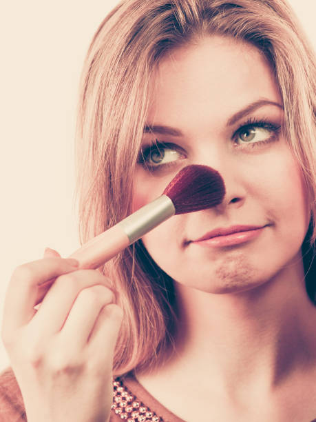 istock Smiling woman holding make up brush 1154855325