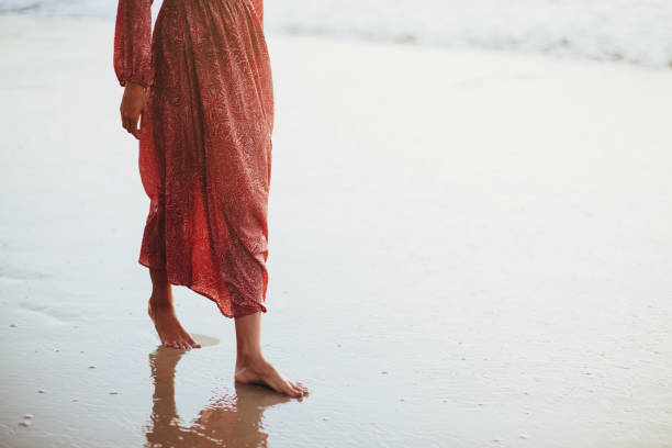 istock Young woman running on seaside path. 1154855509