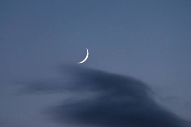 istock The new moon through the clouds 1154855537