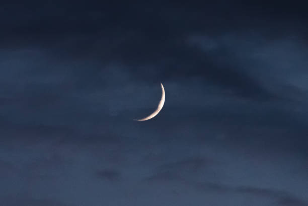 istock The new moon through the clouds 1154855540
