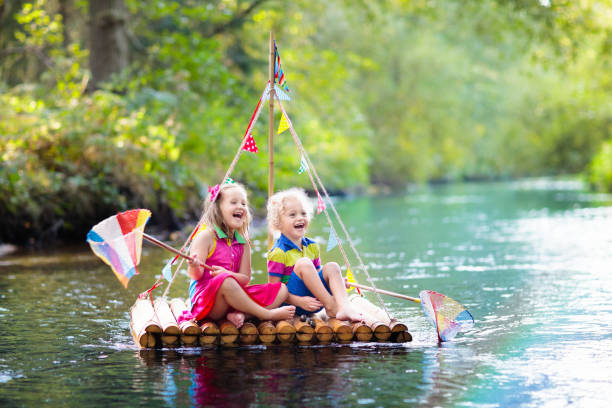 istock Kids on wooden raft 1154857289