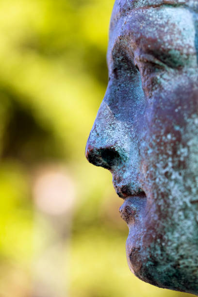 istock Closeup profile of old bronze statue, background with copy space 1154857367