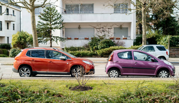 два автомобиля peugeot припаркованная улица - peugeot car french culture france стоковые фото и изображения