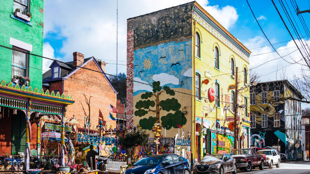 A photo of a typical small town main street in the United States of America. Features old brick buildings with specialty shops and restaurants.
