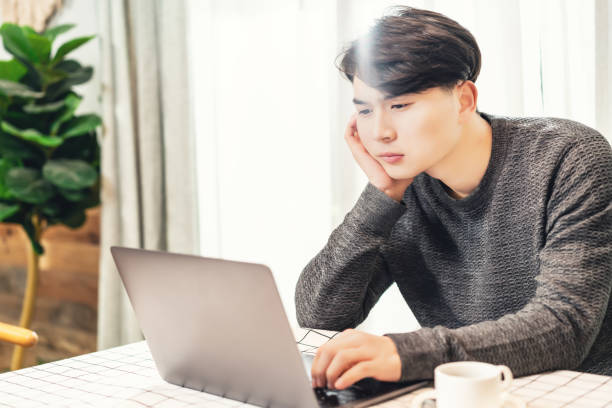 istock Young asian businessman working in coffee shop 1154864313