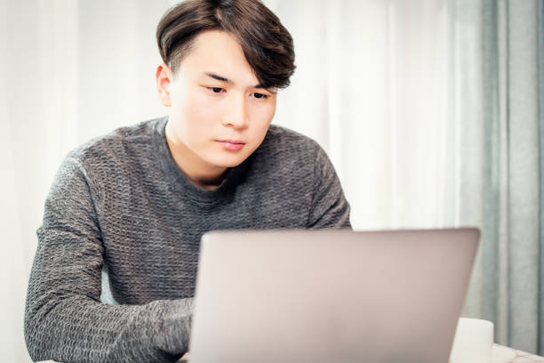 istock Young asian businessman working in coffee shop 1154864334