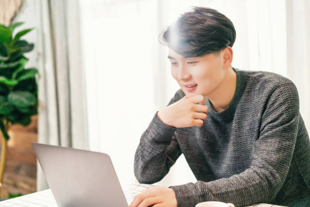 istock Young asian businessman working in coffee shop 1154864336