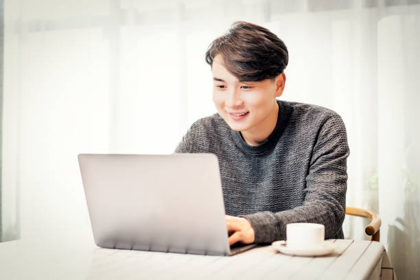 istock Young asian businessman working in coffee shop 1154864339
