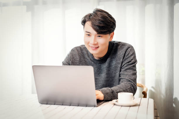 istock Young asian businessman working in coffee shop 1154864344
