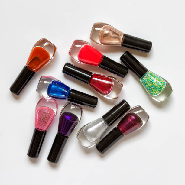 istock Randomly arranged nail polishes on white background 1154865381