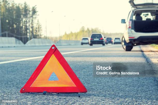 Broken Car On The Side Of The Highway And An Emergency Stop Sign Stock Photo - Download Image Now