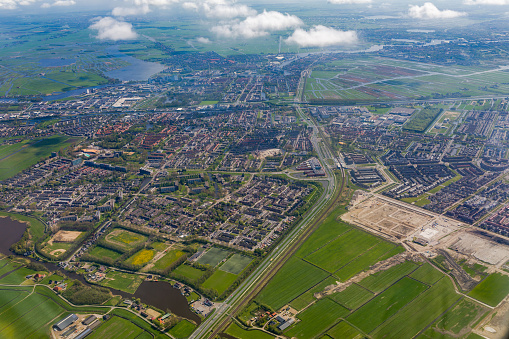 Aerial view of the southern part of Amsterdam with its  green fields and settlements.